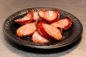 A photo of cut sausage on a plate at Preacher's Smokehouse.